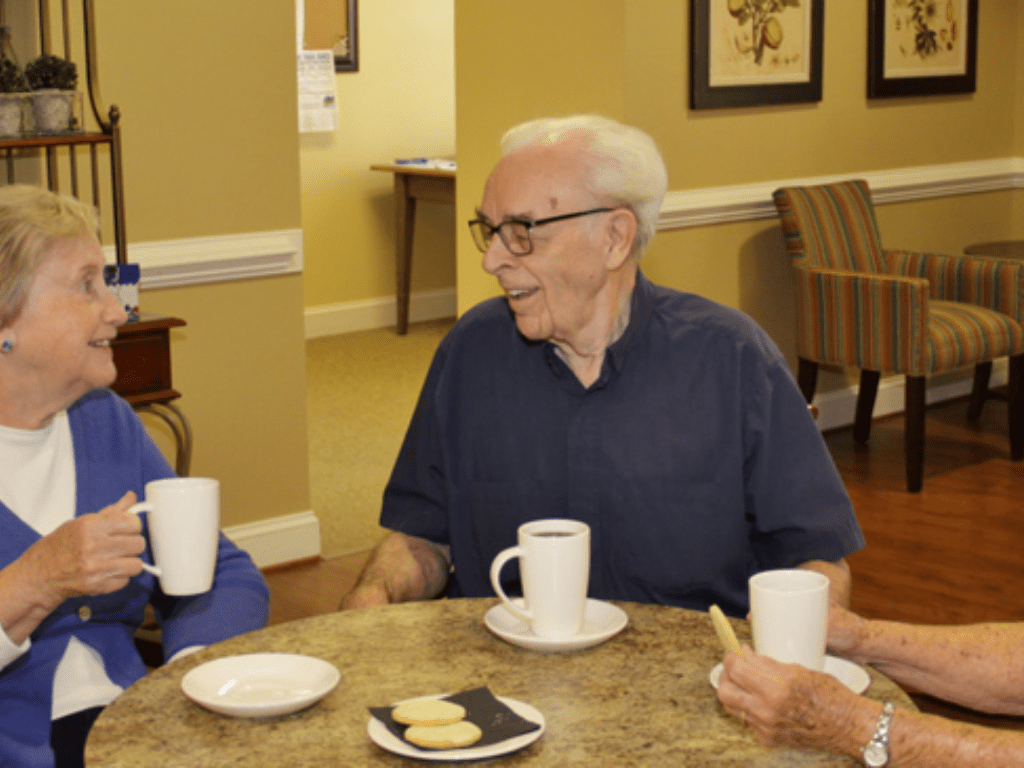 three older people sitting around a table